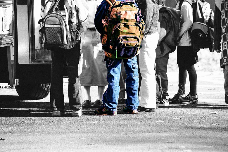 Kids boarding a school bus.